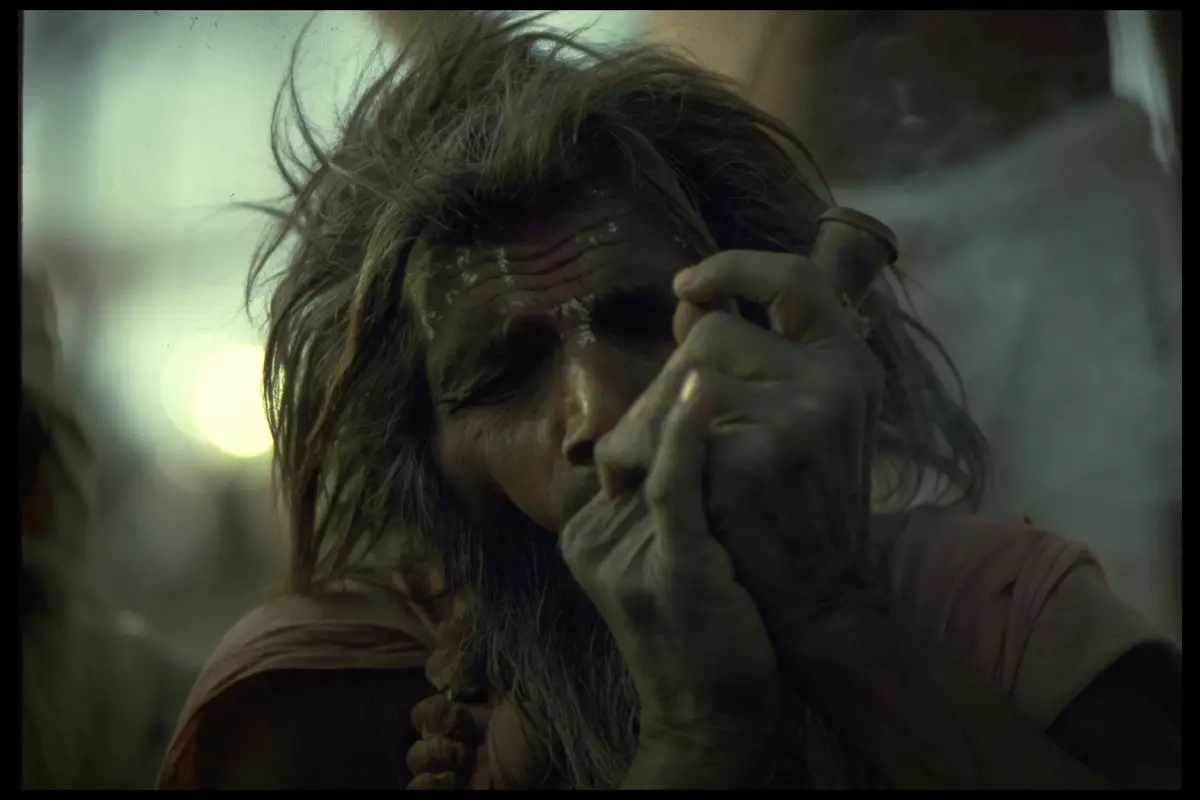 Sadhu smoking chillum lamplight
